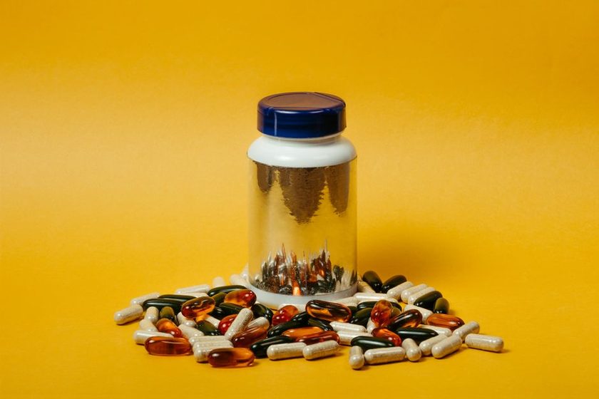 Unbranded capsule bottles on a pharmacy shelf, labels turned away